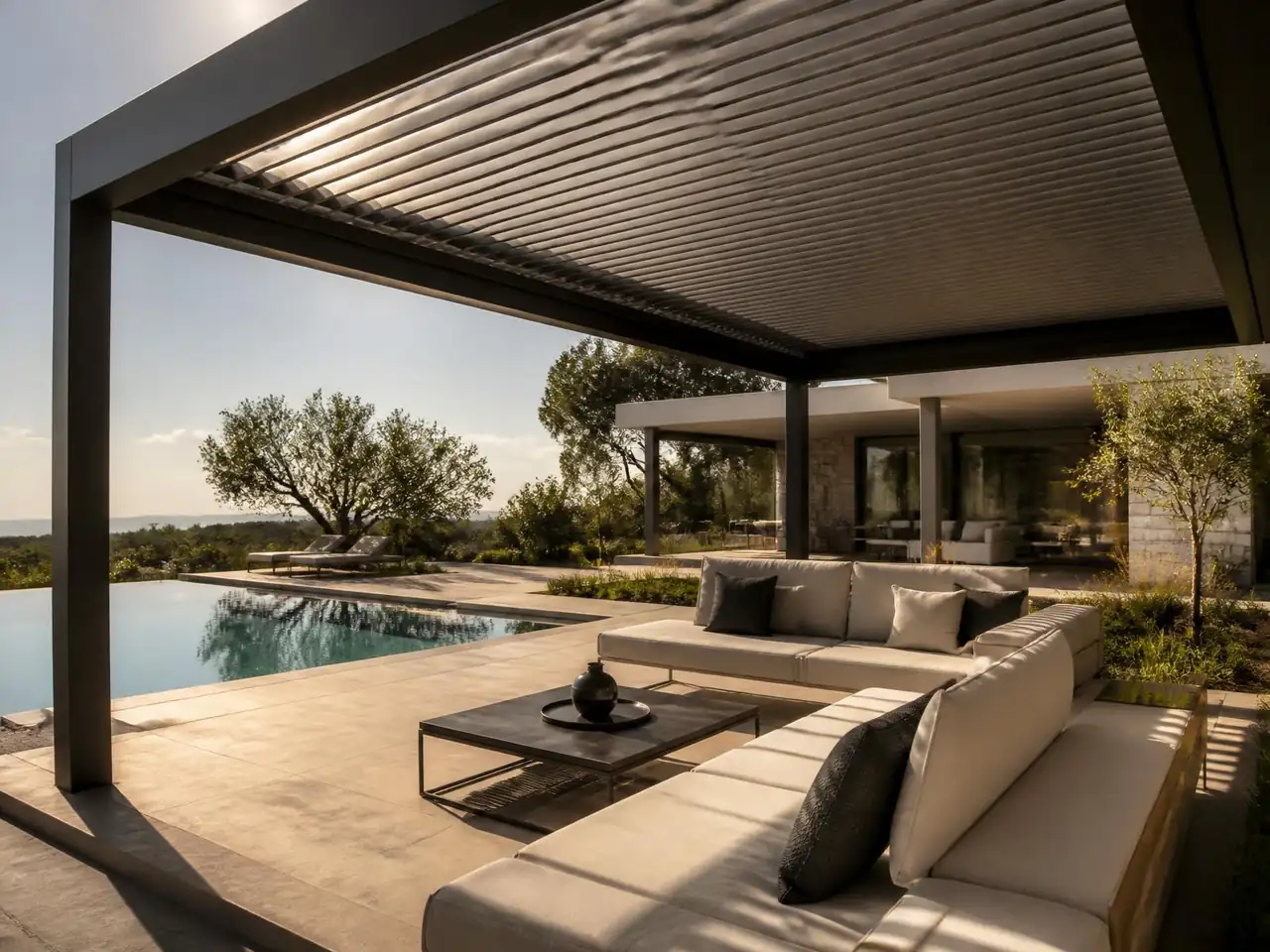 Aluminium pergola shading an outdoor lounge beside a garden